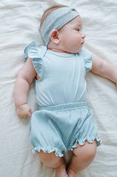 Cute baby model wearing Avauma Mellow Stripe Set Aquamint. Newborn in light blue striped outfit, comfortable baby clothes.